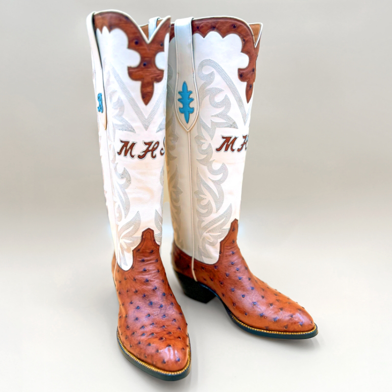 Handcrafted full-quill ostrich leather boots with a tall white shaft and custom monogram detailing by Little's Boot Company.
