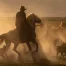 Cowboy herding horses in a meadow.