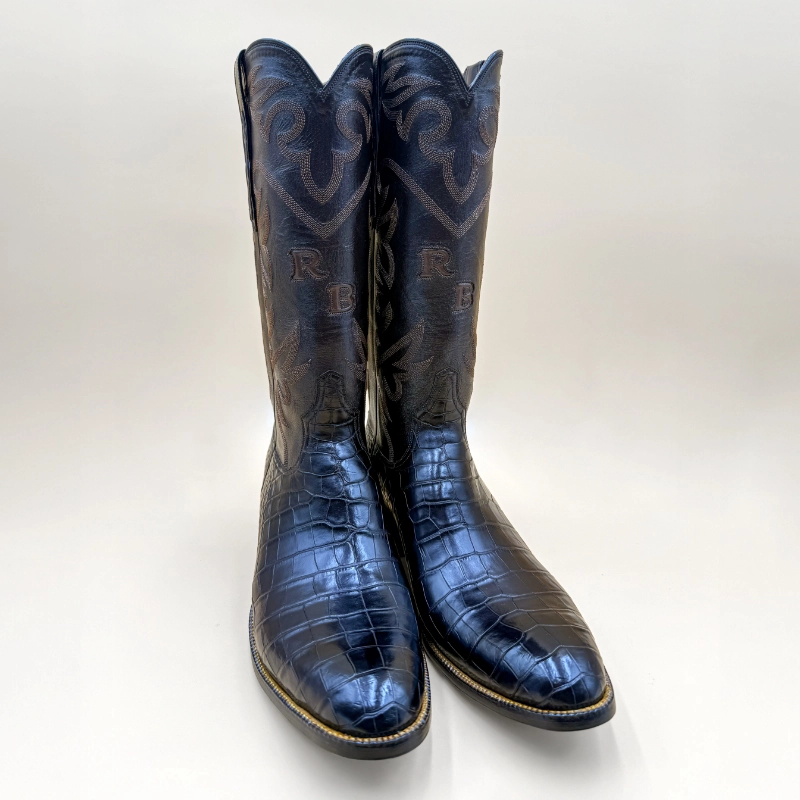 Handcrafted by Little’s Boot Company, these alligator leather cowboy boots feature a tall stitched shaft and custom Western character.