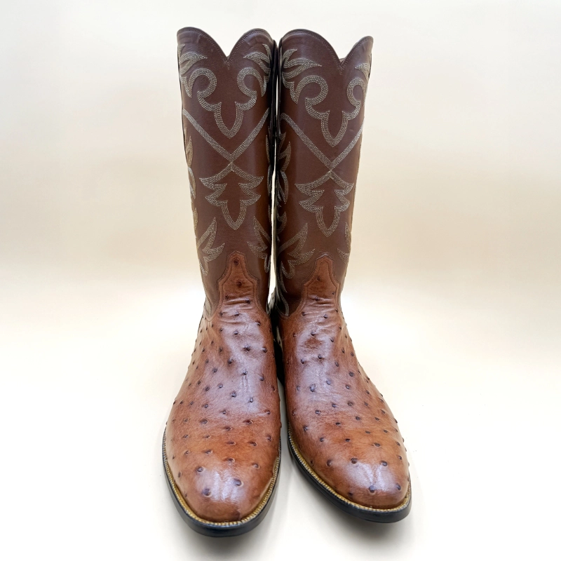 Handcrafted full-quill ostrich cowboy boots featuring a rich brown foot and tall stitched shaft by Little's Boot Co.