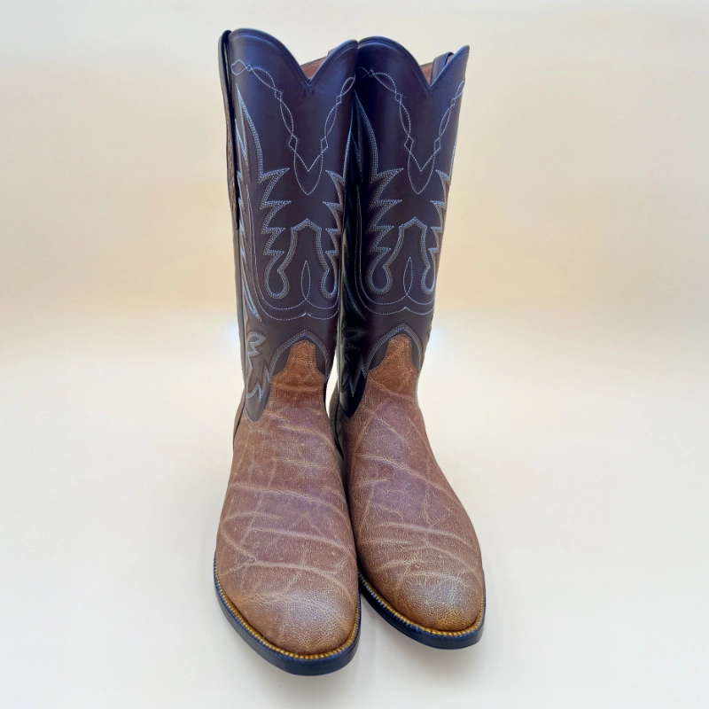 Handcrafted by Little’s Boot Company, these elephant cowboy boots feature a rich brown leather foot and a dark stitched shaft.