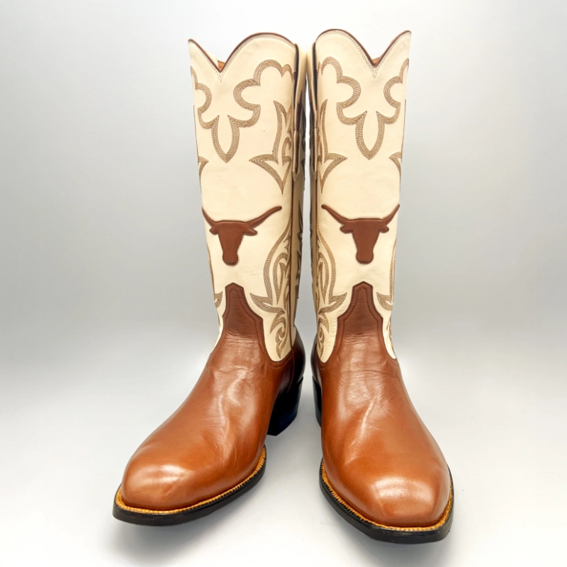 Handcrafted cowboy boots featuring a rich brown leather foot, tall cream shaft, and Longhorn inlay made in Texas by Little's Boot Co.