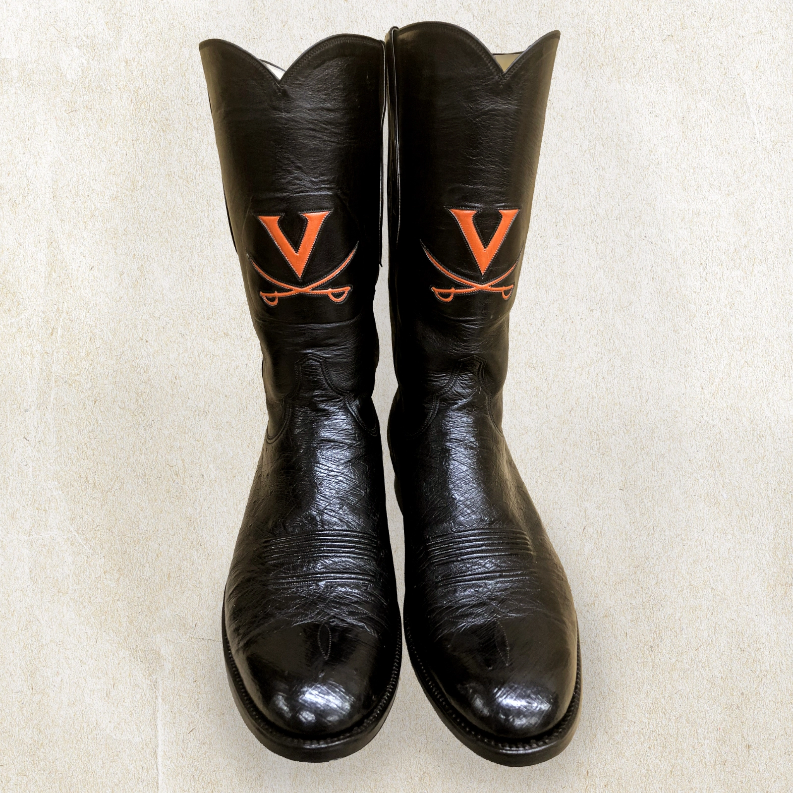 Handcrafted by Little’s Boot Company, these cowboy boots feature custom UVA detailing and a tall leather shaft.